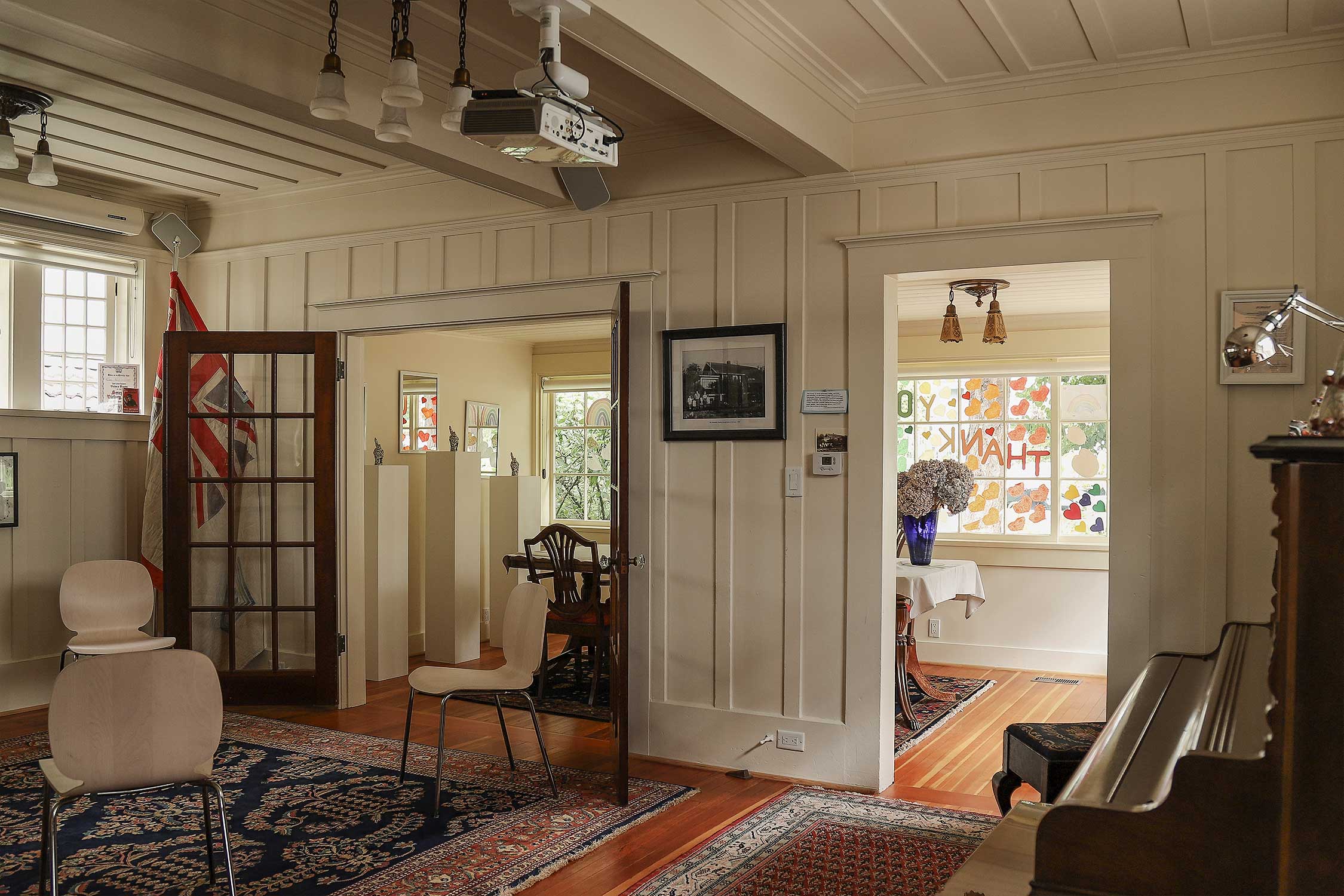 As you come through the doors of the sunroom, you enter the living room which has hosted many events, readings, performances, and important dialogues.